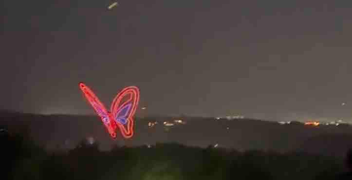 Dollywood drone light show with glowing LED butterfly shape visible from the cabin deck at night